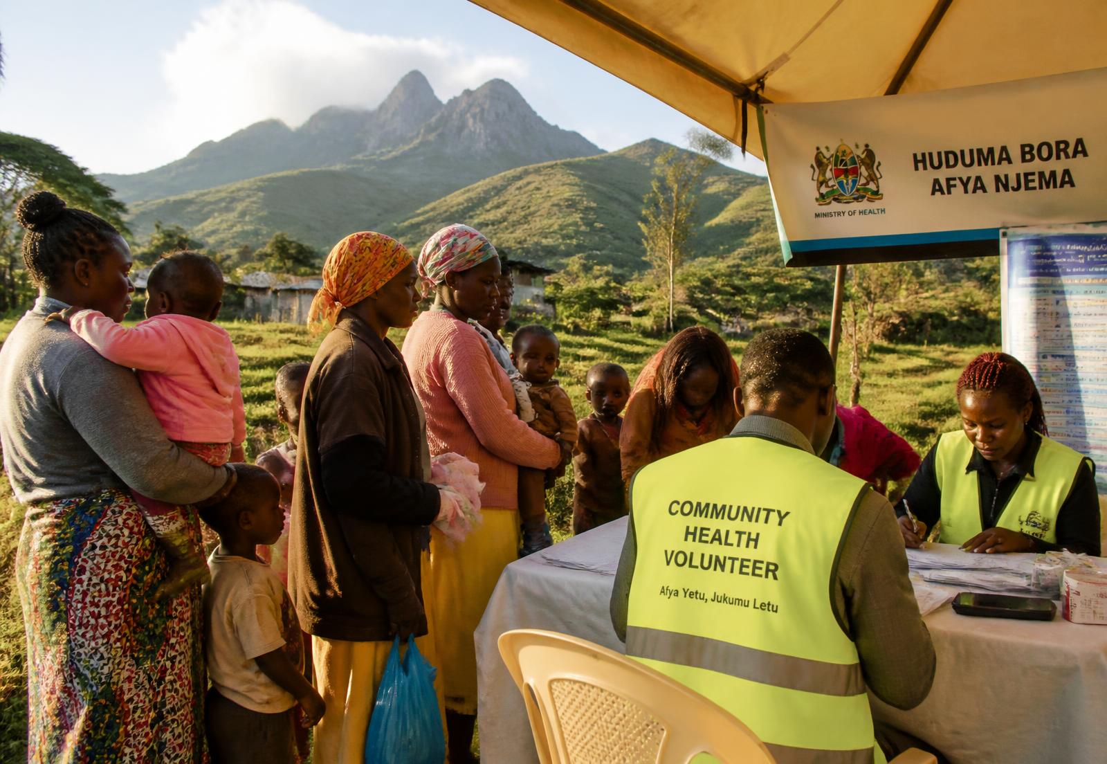 Community health volunteers registering families at an outreach in rural Kenya